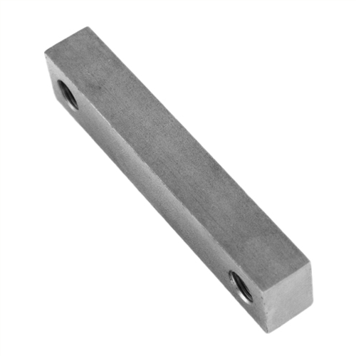 Metal block with two holes on a white background.
