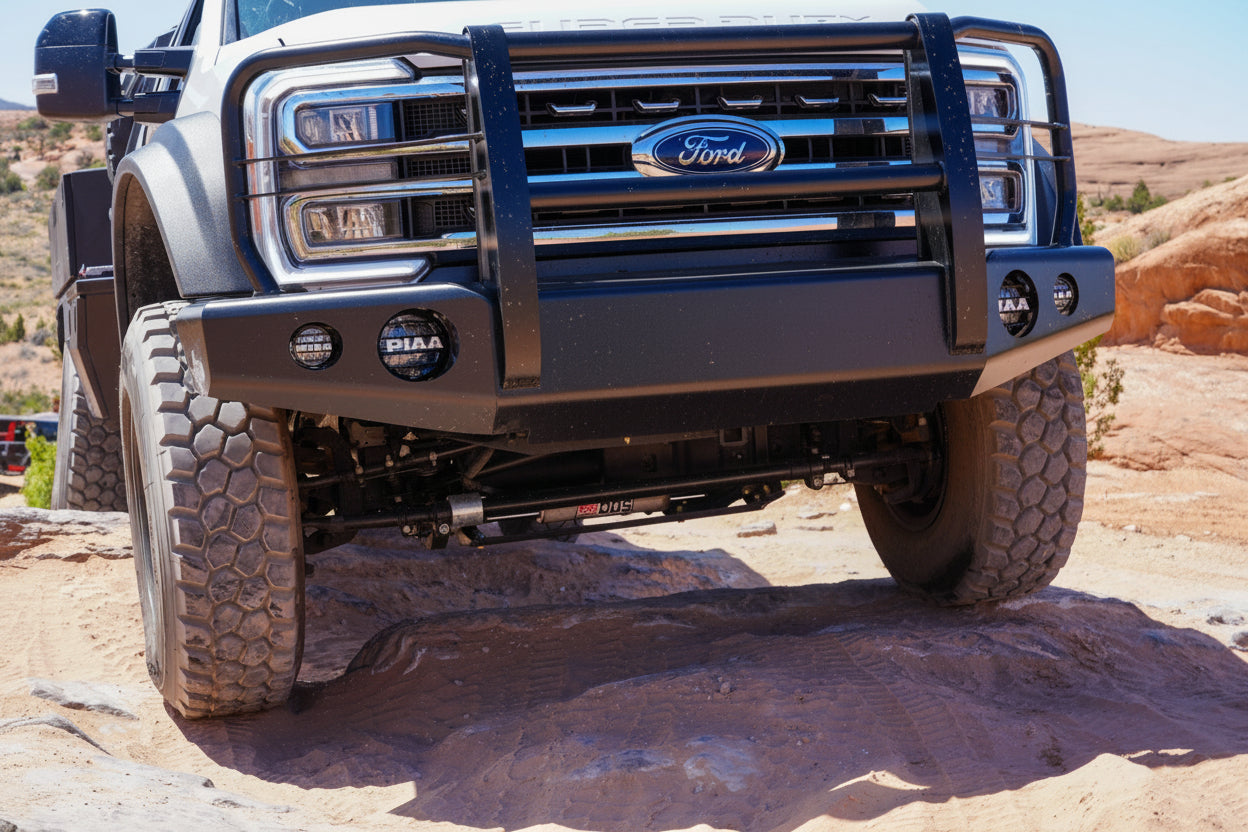 PSC Ford F550 truck with large off-road tires in Moab, Utah climbing a obstacle with the PSC DDS shown. 