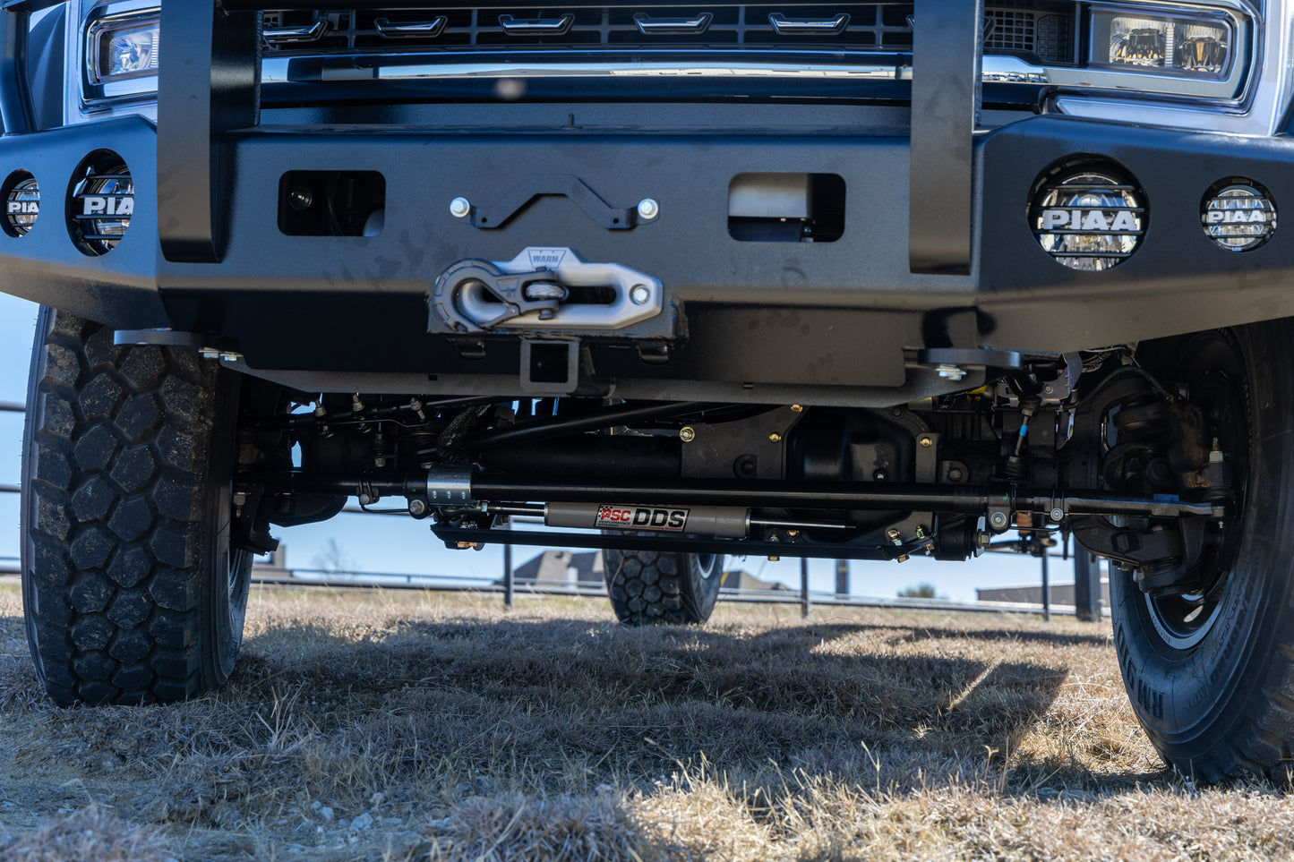 Close-up of a the PSC F550 front bumper with PIAA lights and the PSC DDS on a grassy field.