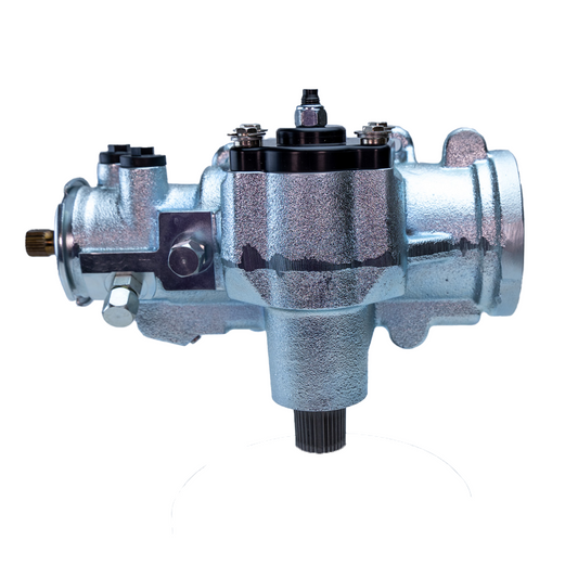 Side view of a silver PSC steering gear featuring a machined aluminum housing, black top cap, and precision mounting brackets on a white background.