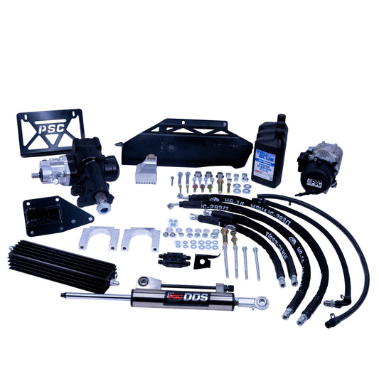 A complete PSC DDS hydraulic power steering kit with various black and silver components, including hoses, brackets, a shock absorber, fluid bottle, and mounting hardware, arranged on a solid white background.