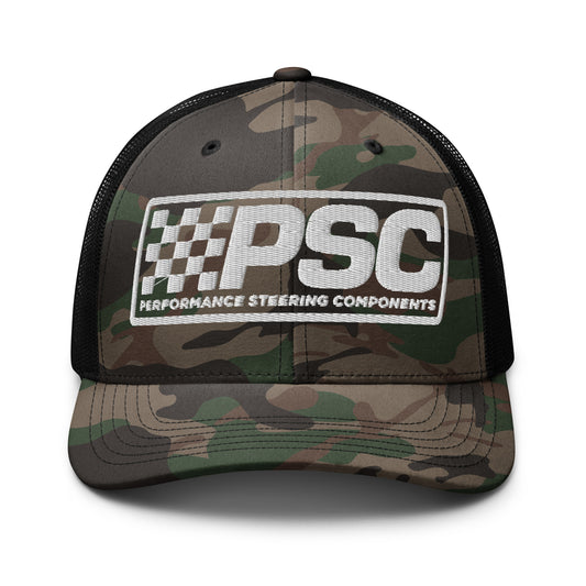 Product mockup image of the back of a trucker cap in a camo greens color with green camo bill, black net back and black accents. The background behind the cap is white. The PSC logo with "PSC", flag and words "Performance Steering Components" are in white and are embroidered on the center of the cap.