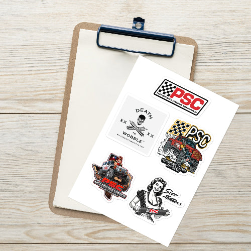 Product mockup of a PSC Sticker sheet set. The stickers are kiss cute featuring 5 stickers. There is a PSC logo, Square Death to Wobble, Size Matters, PSC monster truck and PSC Jeep with pinup girl stickers featured. The background shows a clipboard and wooden table. 