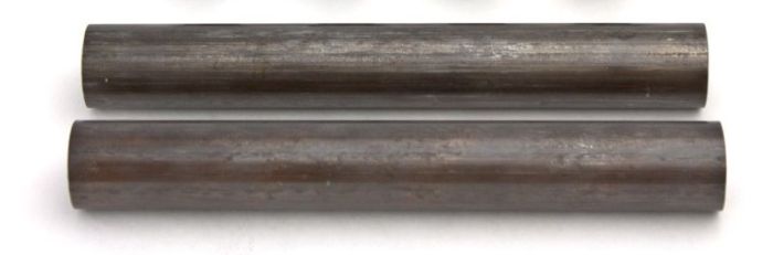 Two cylindrical metal rods on a white background