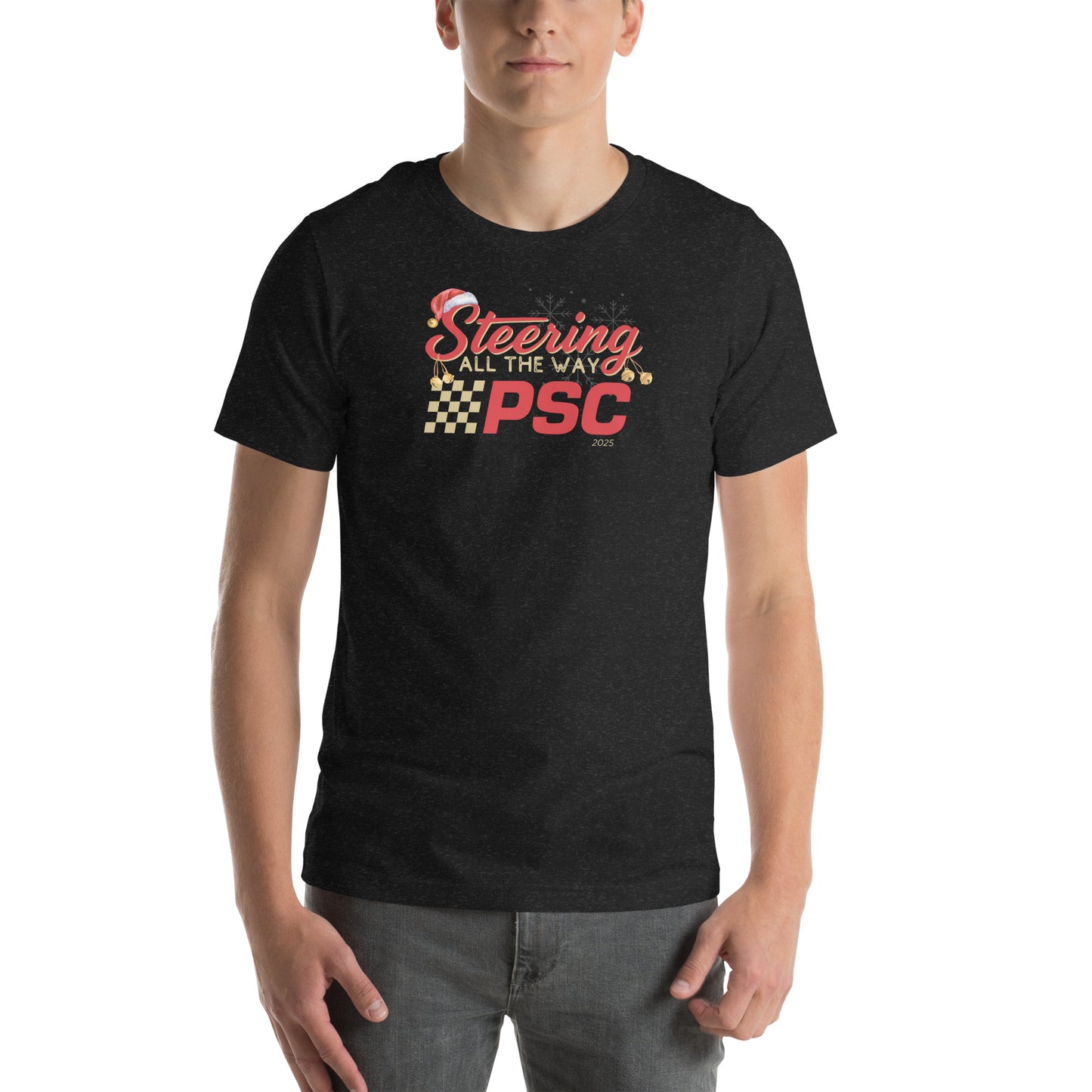Front view of an adult model wearing a heather black short-sleeve T-shirt with a PSC logo and the phrase ‘Steering All the Way PSC 2025’ printed across the chest in red and gold lettering. There is a Santa hat on the "S" in steering, bells handing off the bottom of the "S" and "g" in steering and translucent snowflakes in the background as well as "2025" right bottom corner offset.
