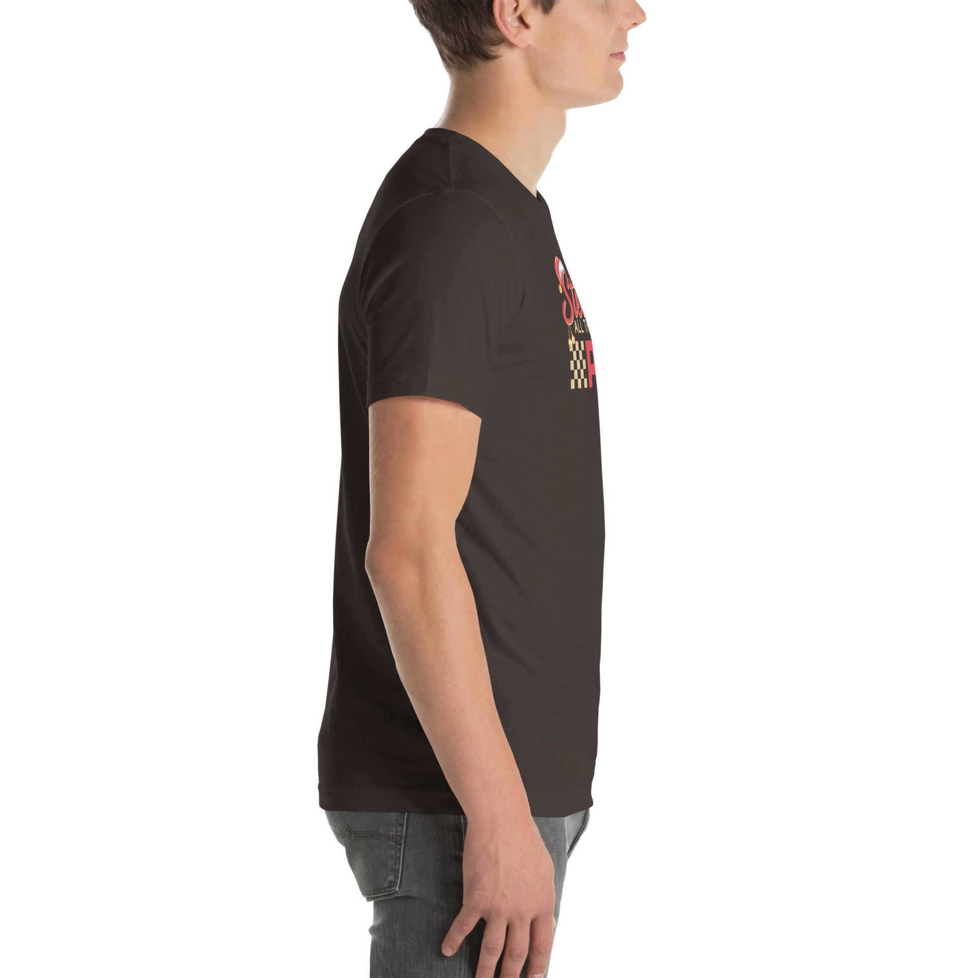 Side view of an adult model facing the right edge of the screen wearing a brown short-sleeve T-shirt you can see the edge of a red and gold design on the front of the shirt. The background is white.