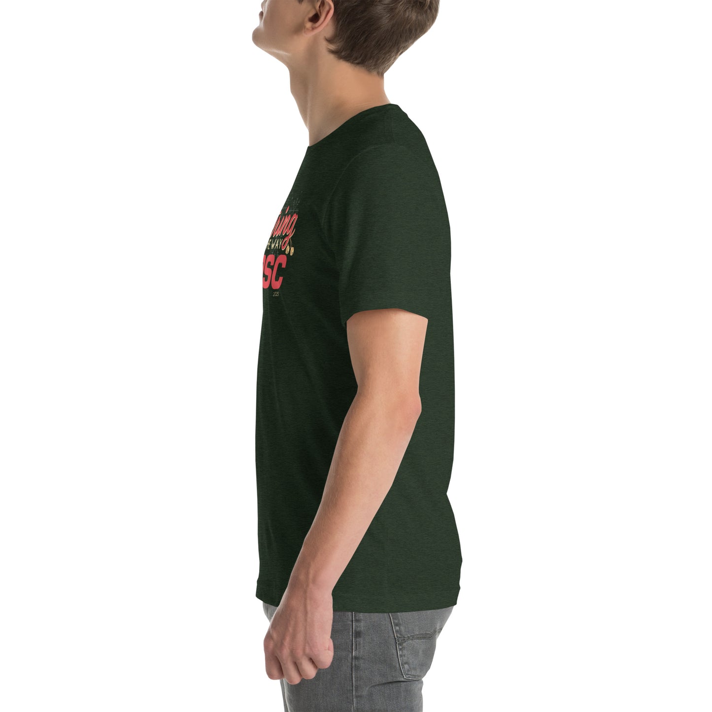 Side view of an adult model facing the left edge of the screen wearing a heather emerald green short-sleeve T-shirt you can see the edge of a red and gold design on the front of the shirt. The background is white.