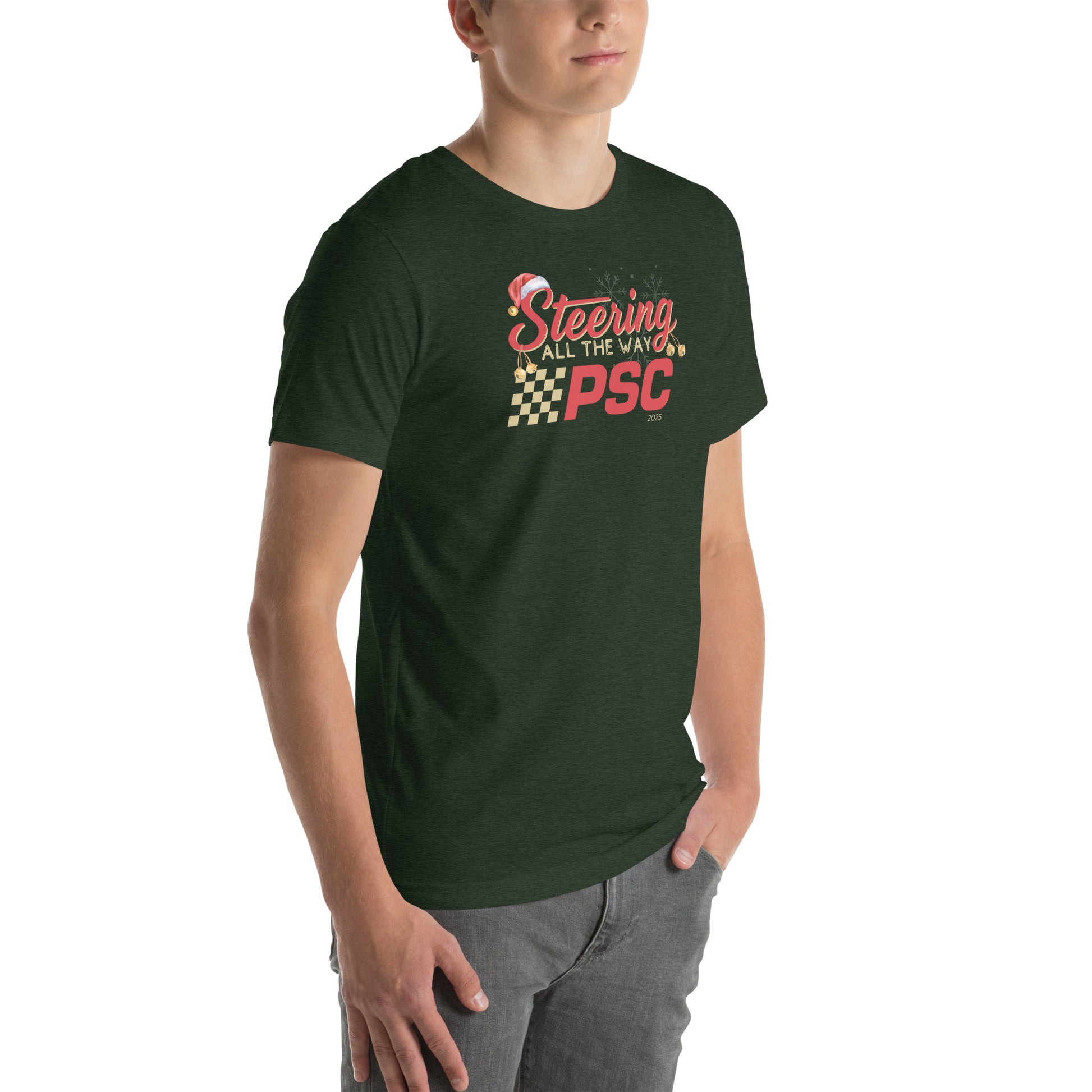 Angled front view of an adult model wearing a heather emerald green short-sleeve T-shirt with a PSC logo and the phrase ‘Steering All the Way PSC 2025’ printed across the chest in red and gold lettering. There is a Santa hat on the "S" in steering, bells handing off the bottom of the "S" and "g" in steering and translucent snowflakes in the background as well as "2025" right bottom corner offset. He is facing the right frame of the image.