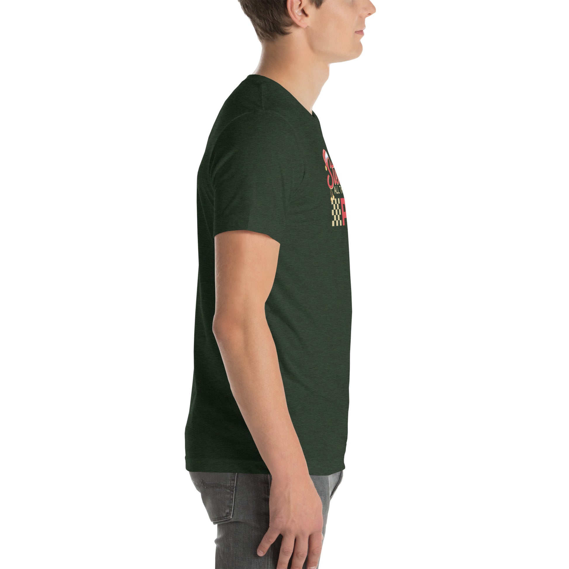 Side view of an adult model facing the right edge of the screen wearing a heather emerald green short-sleeve T-shirt you can see the edge of a red and gold design on the front of the shirt. The background is white.