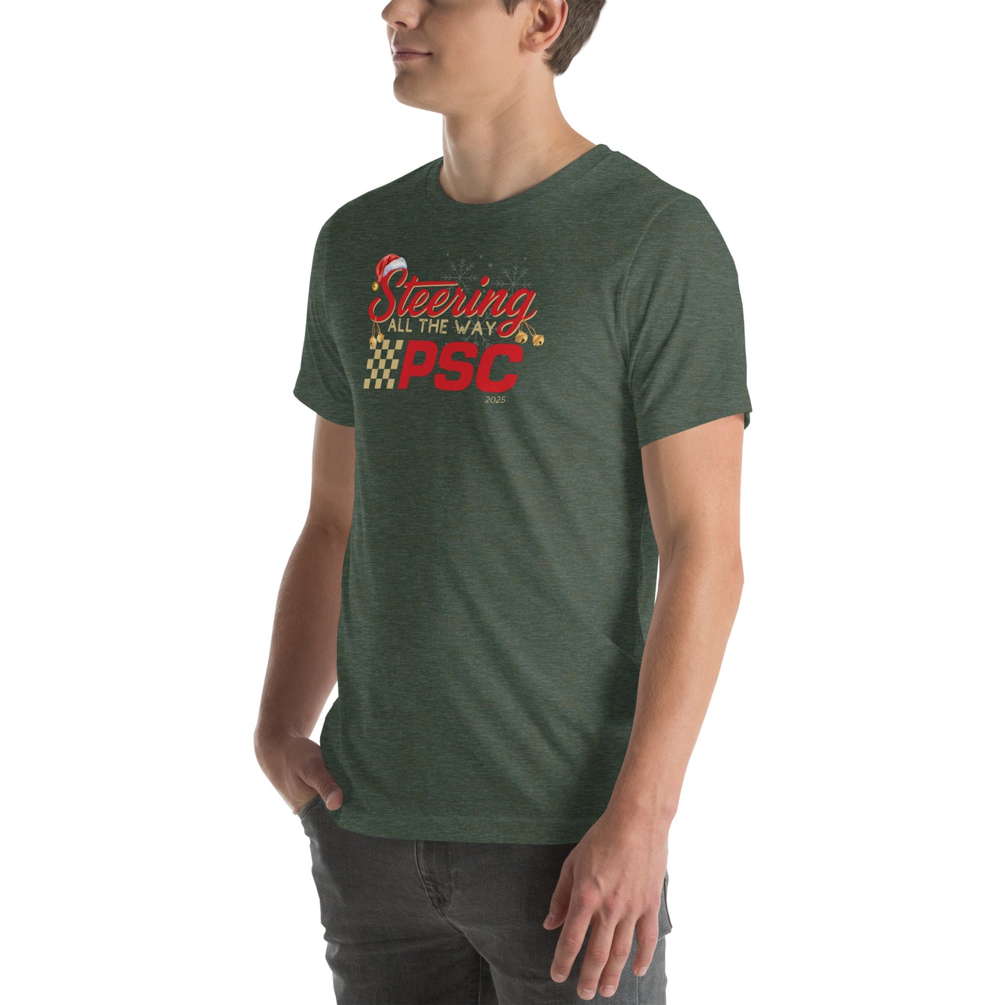 Angled front view of an adult model wearing a heather forest green short-sleeve T-shirt with a PSC logo and the phrase ‘Steering All the Way PSC 2025’ printed across the chest in red and gold lettering. There is a Santa hat on the "S" in steering, bells handing off the bottom of the "S" and "g" in steering and translucent snowflakes in the background as well as "2025" right bottom corner offset. He is facing the left frame of the image.