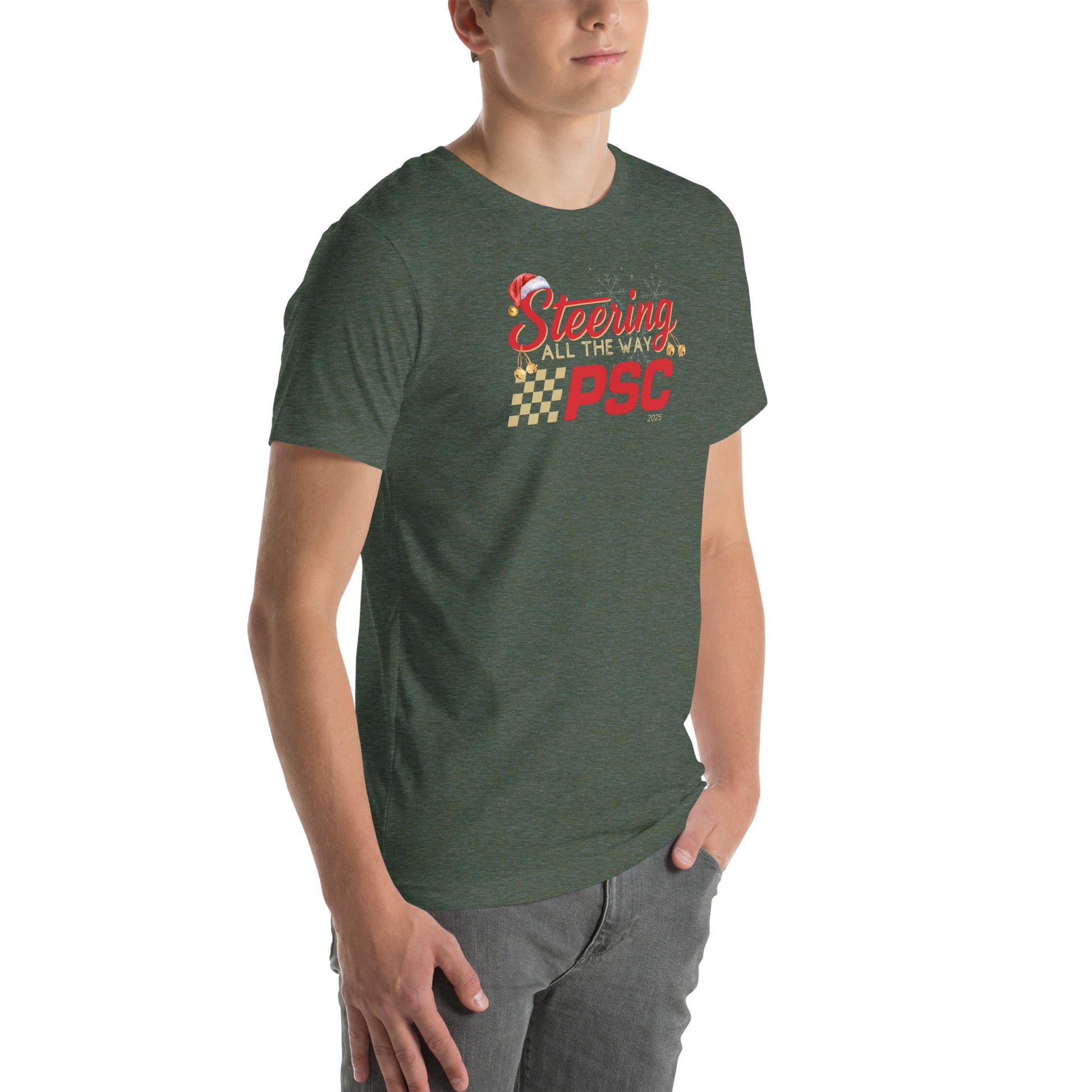 Angled front view of an adult model wearing a heather forest green short-sleeve T-shirt with a PSC logo and the phrase ‘Steering All the Way PSC 2025’ printed across the chest in red and gold lettering. There is a Santa hat on the "S" in steering, bells handing off the bottom of the "S" and "g" in steering and translucent snowflakes in the background as well as "2025" right bottom corner offset. He is facing the right frame of the image.
