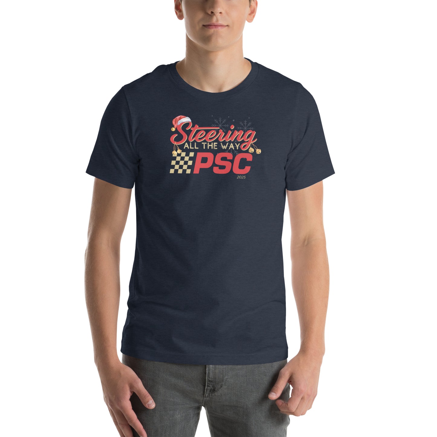 Front view of an adult model wearing a heather navy blue short-sleeve T-shirt with a PSC logo and the phrase ‘Steering All the Way PSC 2025’ printed across the chest in red and gold lettering. There is a Santa hat on the "S" in steering, bells handing off the bottom of the "S" and "g" in steering and translucent snowflakes in the background as well as "2025" right bottom corner offset.