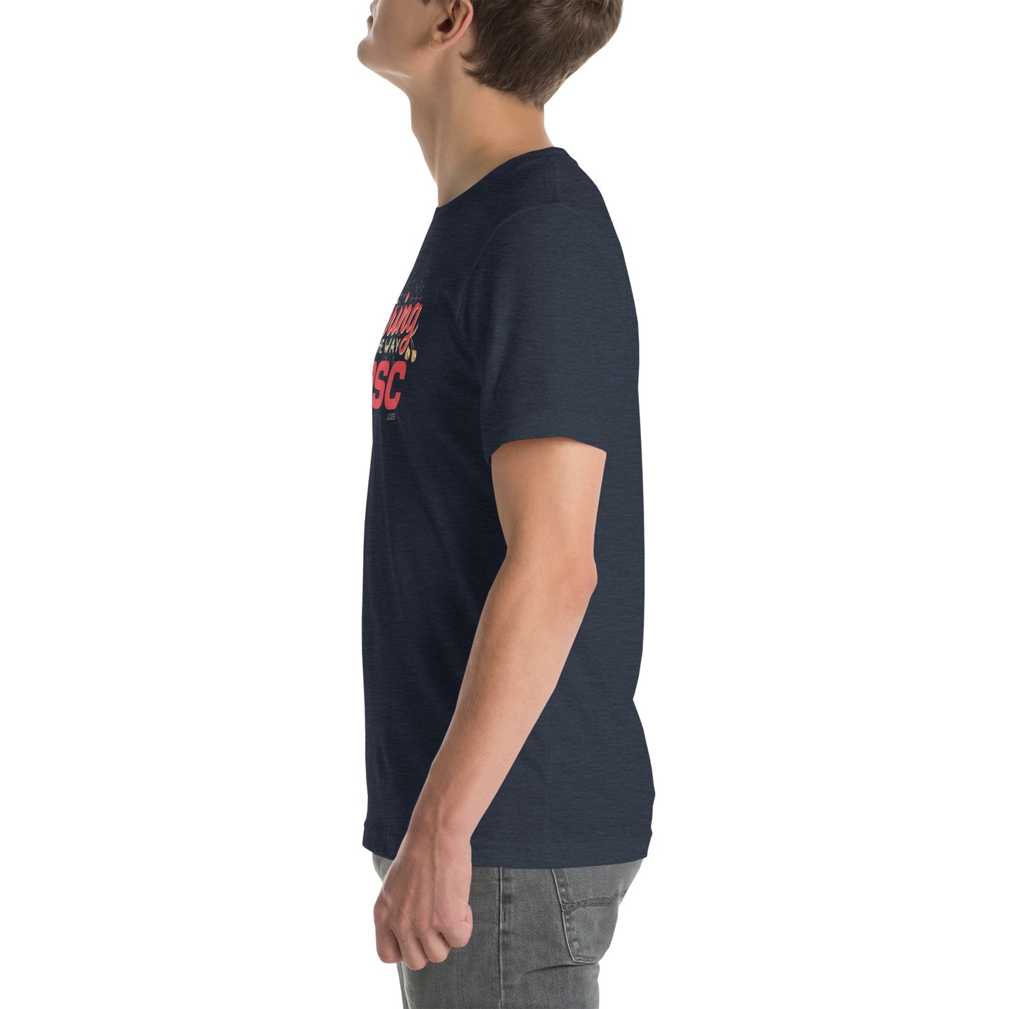 Side view of an adult model facing the left edge of the screen wearing a heather navy blue short-sleeve T-shirt you can see the edge of a red and gold design on the front of the shirt. The background is white.