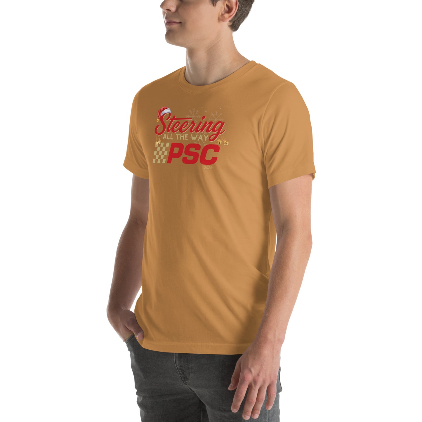 Angled front view of an adult model wearing a toast orange-brown short-sleeve T-shirt with a PSC logo and the phrase ‘Steering All the Way PSC 2025’ printed across the chest in red and gold lettering. There is a Santa hat on the "S" in steering, bells handing off the bottom of the "S" and "g" in steering and translucent snowflakes in the background as well as "2025" right bottom corner offset. He is facing the left frame of the image. 